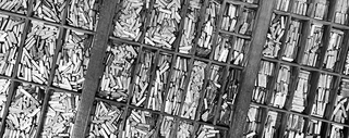 Black-and-white photo of the compartments of a letterpress typecase filled with lead type.